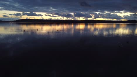 Aerial-view-of-lagoon-in-Sant'Antioco-island,-Sardinian-town,-dolly-out,-dusk