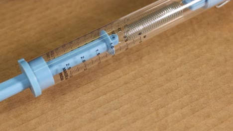 a spring scale measures friction on cardboard, showing gradual movement and tension changes. macro view highlights details and precision