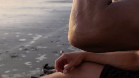 young couple sitting on the sand