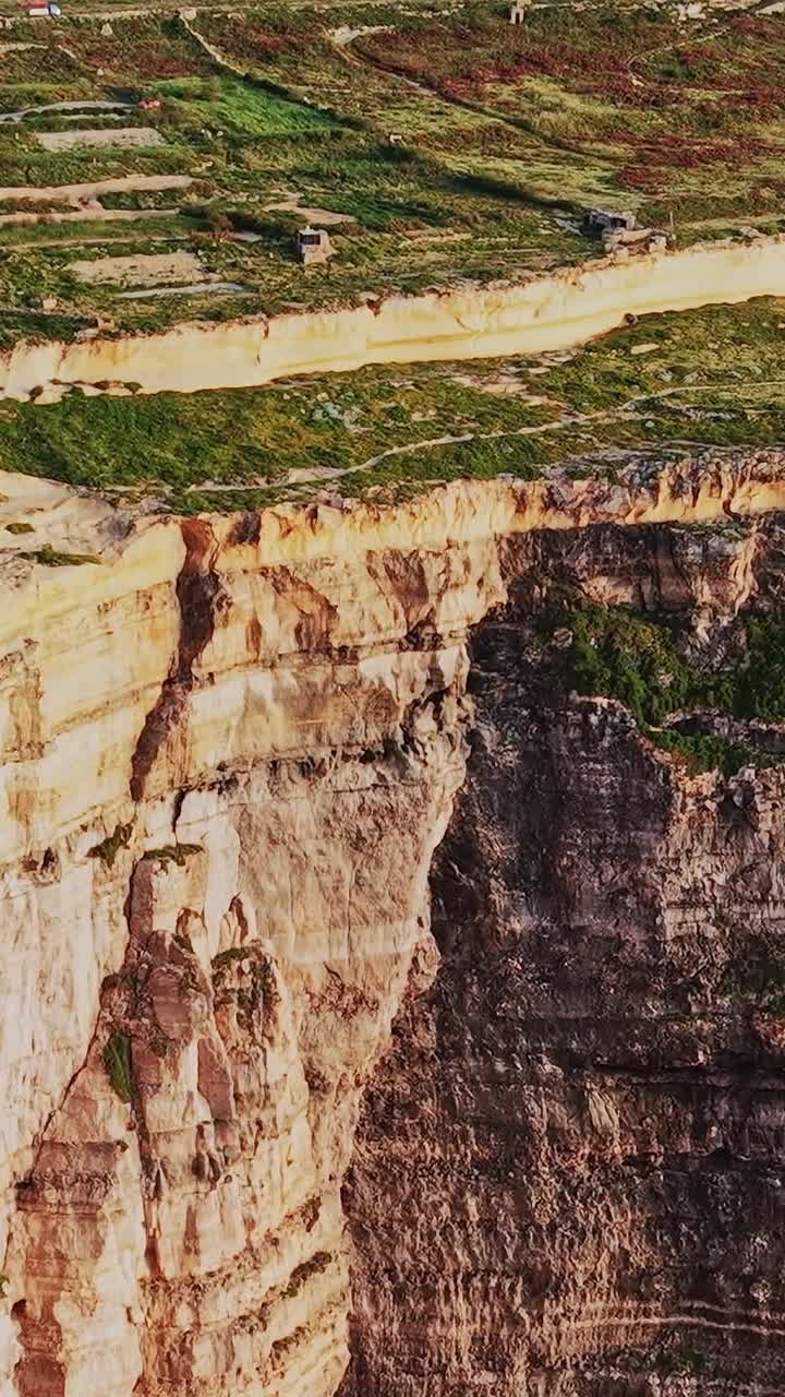 Cliffs and fields at the coast of malta during daylight hours