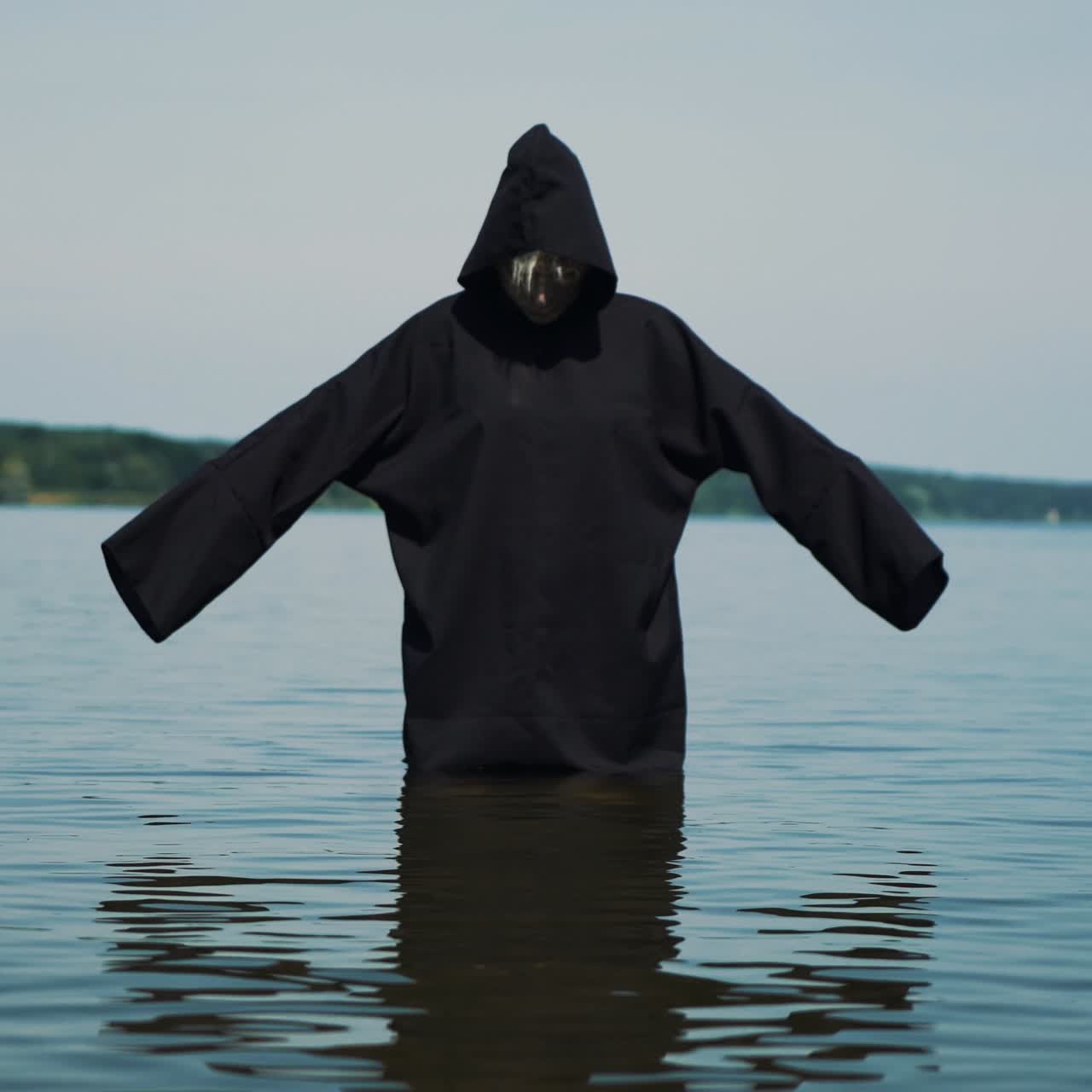 Terrible witch on the river bank. Mysticism of Halloween