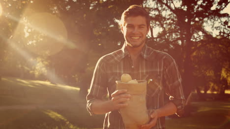 Happy-handsome-man-holding-bag-with-vegetables-