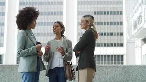 businesswomen discussing in an urban setting