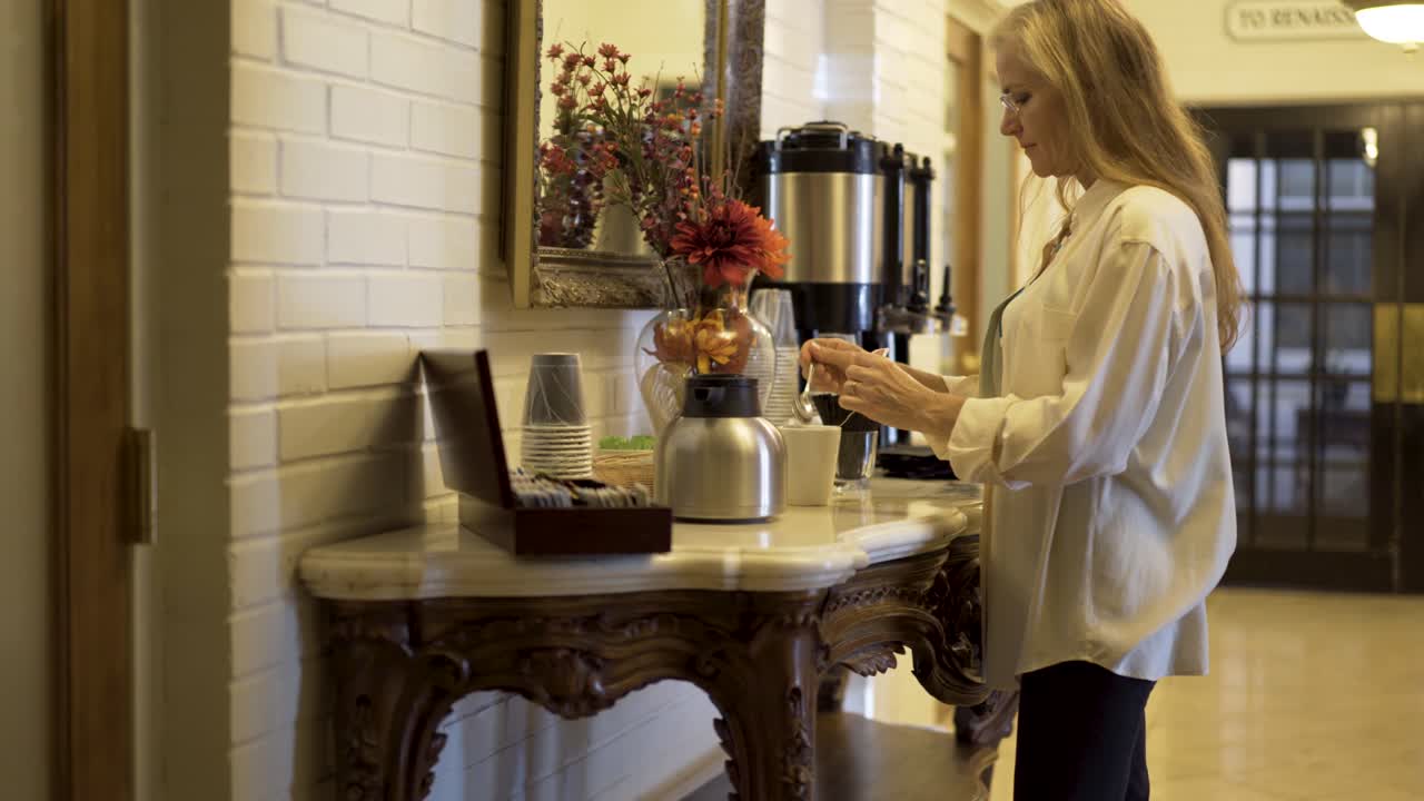 Woman making coffee at a table
