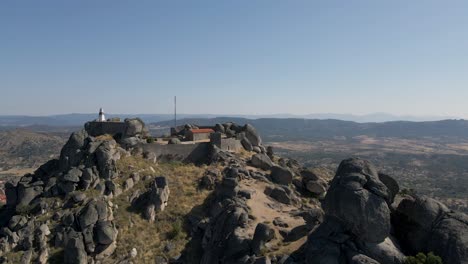 aerial drone approach of ancient monsanto hilltop castle in portugal