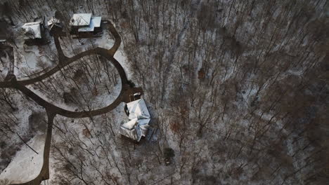 Aerial-shot-of-snow-covered-Mount-Sequoyah-in-Arkansas-with-winding-paths-and-bare-trees