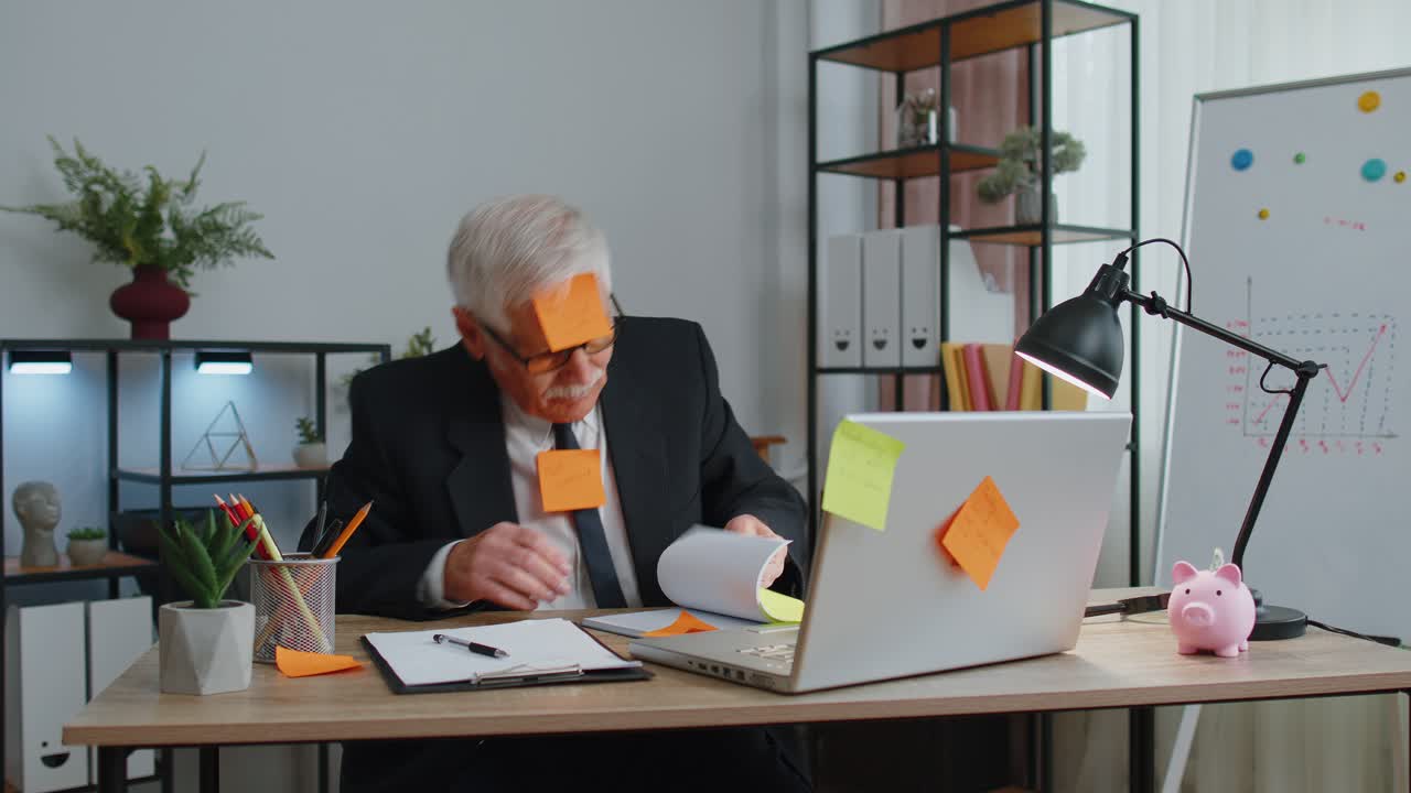 Tired exhausted senior business man office manager with laptop sticky notes sticks with many tasks