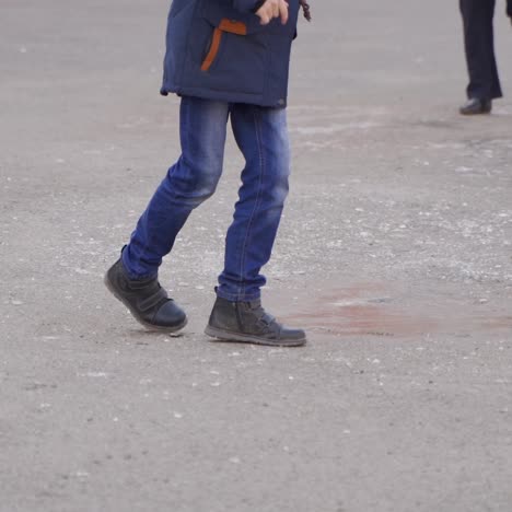 happy school kids slide on the ice. frosty winter day. school friends. winter fun in the schoolyard