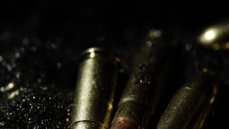 Macro-detail-shot-of-cartridge-bullets-firearm-ammunition-on-gunpowder-pile