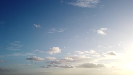 landscape shot panning across a beautiful blue sky with sun and cloud