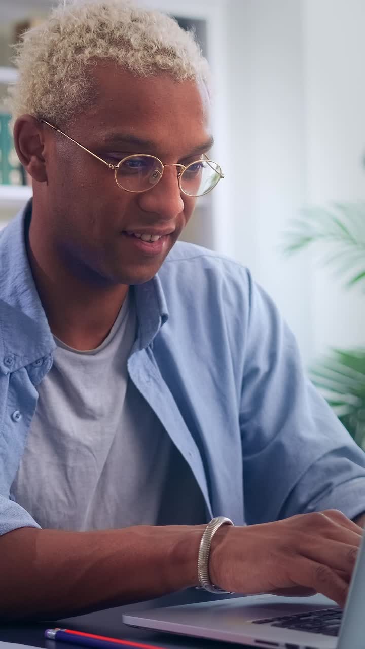 Focused young african american man working on his laptop indoors