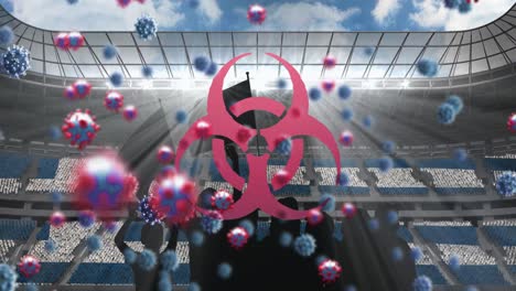 biohazard symbol and covid-19 cells floating over silhouette of fans cheering against sports stadium