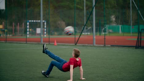 young boy jumps and shoots the ball on the field