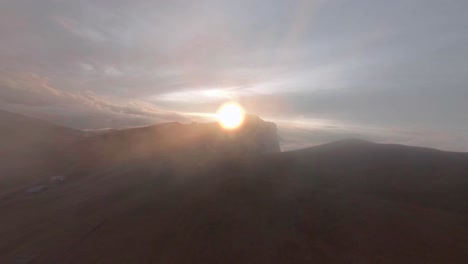 flying through the beautiful landscape of seceda dolomites, italy to the sun - aerial shot