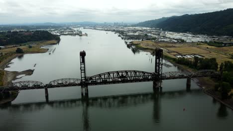 US, Oregon, Portland, St Johns, 2025-07-26 - Drone view of a freight train going across the Train Bridge