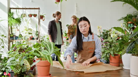 woman wrapping a gift in a plant shop