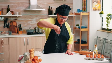 Sieving-flour-on-wooden-table