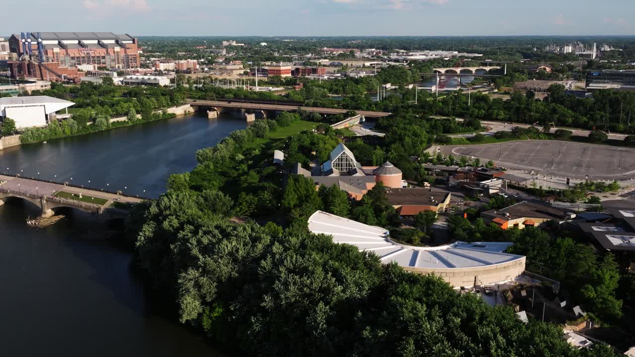 Drone orbits downtown Indianapolis with views of White River, skyline, and surrounding architecture