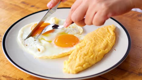 cutting eggs and omelet on a plate