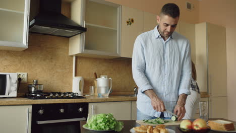 couple cooking and kissing in the kitchen