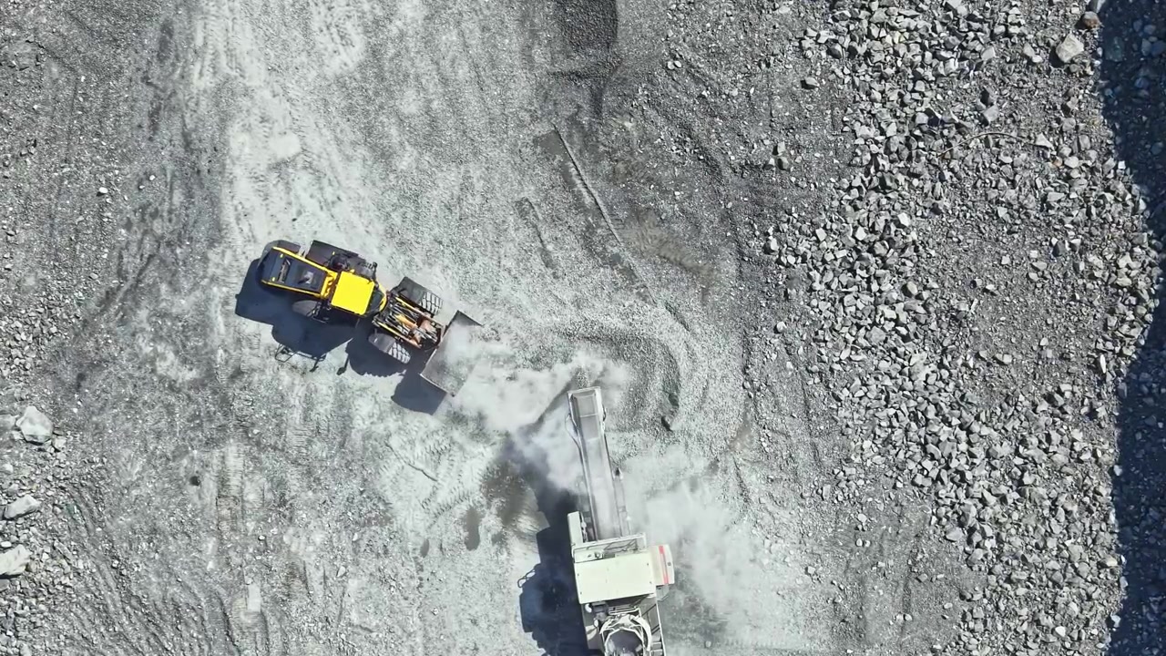 Granite quarry work with machinery moving and processing stones