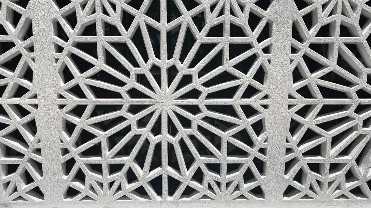 A geometric Islamic pattern crafted from GFRC forms an attractive, repeating architectural element on a wall. This decorative feature enhances the structure with traditional aesthetic design