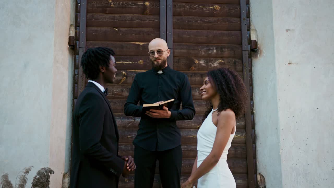 Interracial Couple Getting Married by Priest