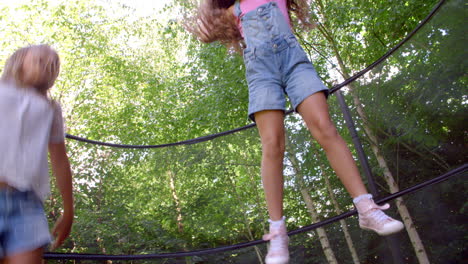 two girls jumping on trampoline shot in slow motion