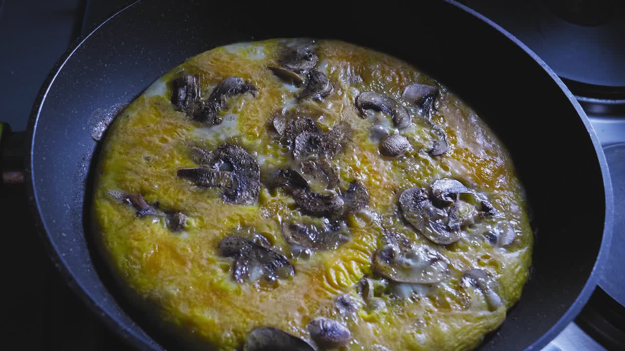 Scrambled Eggs With Sliced Mushrooms Cooking In A Skillet