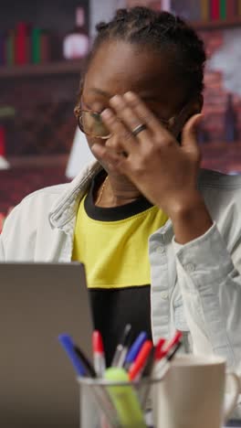 vertical video tired woman in living room office sighing, overworked by tasks