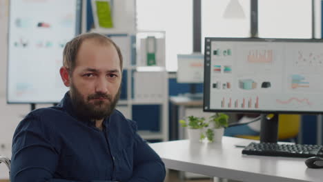 Close-up-of-sad-disabled-entrepreneur-sitting-in-wheelchair-looking-at-camera