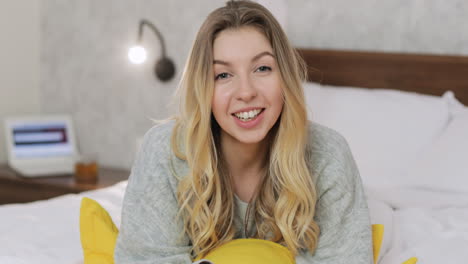 woman relaxing on bed, smiling
