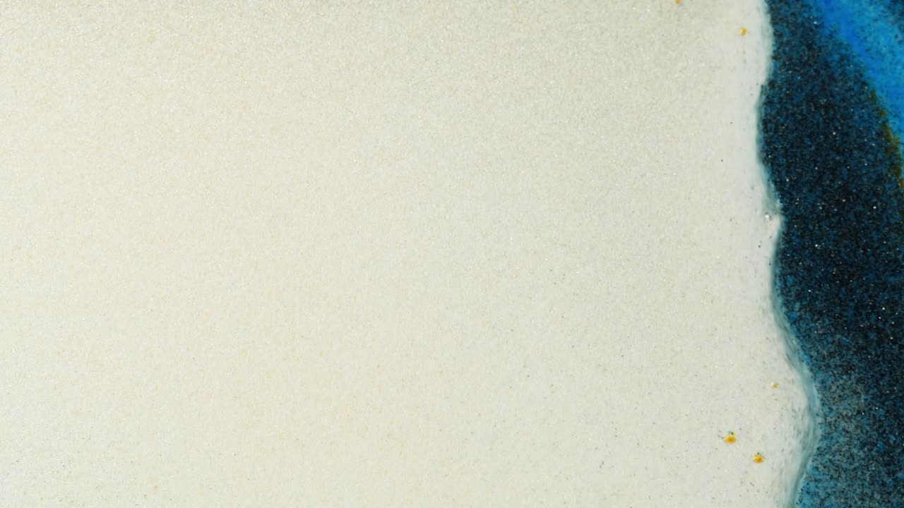 Close-up of a ceramic surface with sand and blue glaze