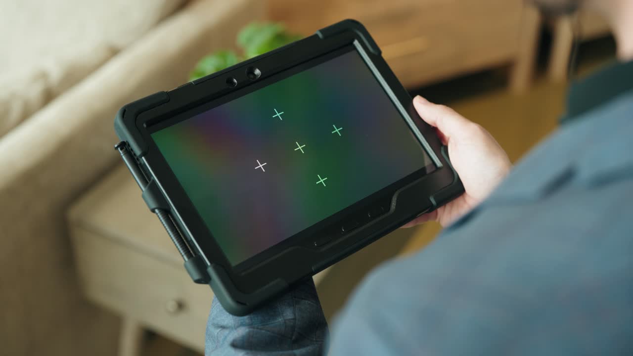 Slow Motion Static Over-Shoulder Shot of Tablet With Motion Tracking Markers