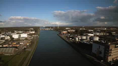 -Drone-aerial-pull-from-windmills-on-the-side-of-a-river-in-Albertkanaal