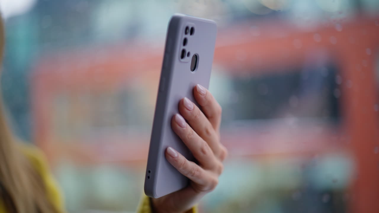 Businesswoman hands touching cellphone touchscreen browsing app office closeup