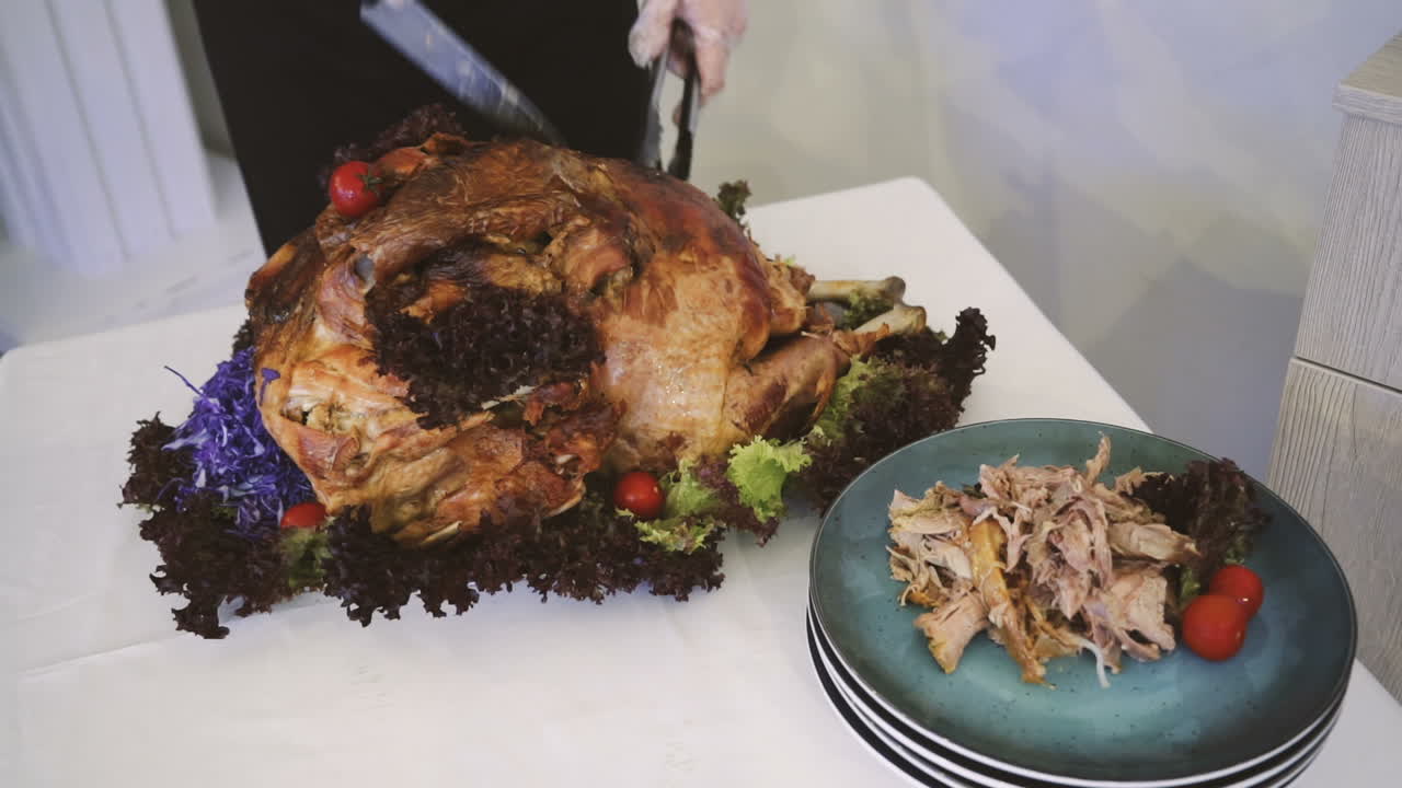 Thanksgiving or Christmas turkey dinner. Hands of a man carving a roast turkey