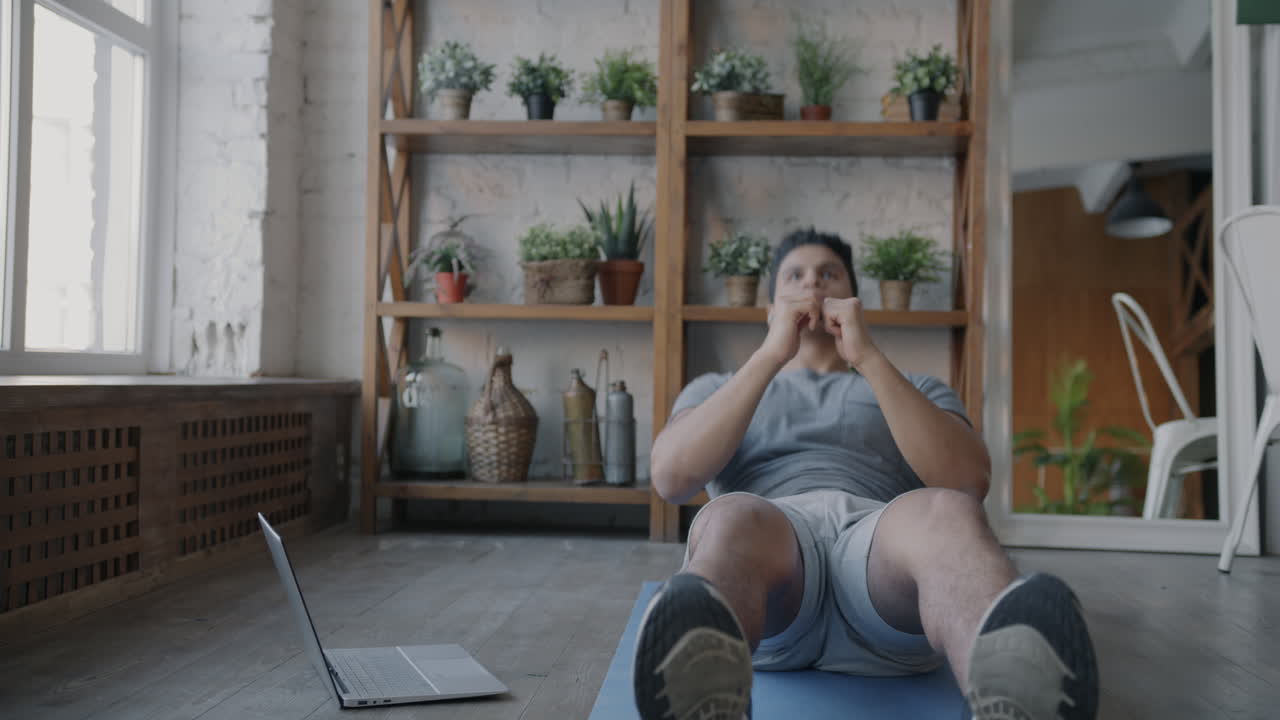 Man Doing Online Workout Routine at Home