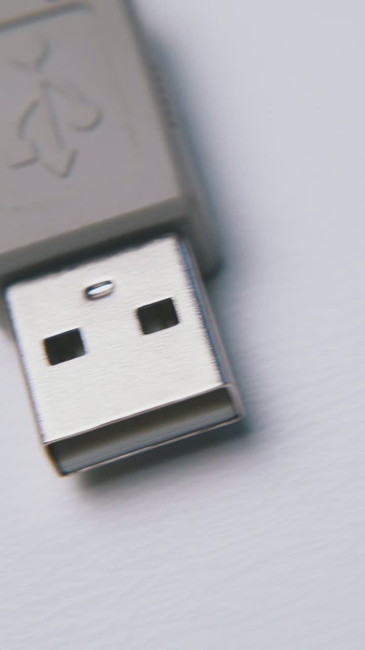 motion past grey usb cable for devices connection to computer on empty white background extreme close view