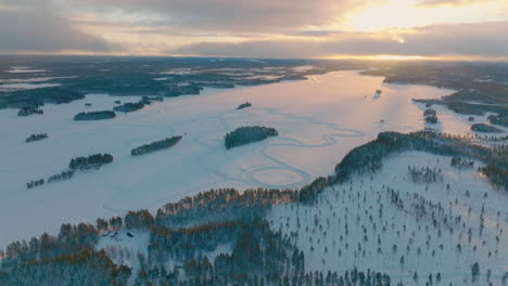 Lapland-polar-circle-snow-covered-racetrack-landscape-aerial-view-with-sunrise-skyline