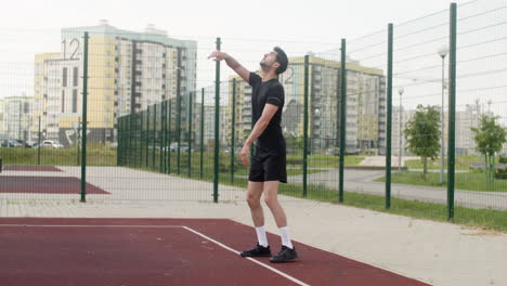 side view of brunet man hitting a volleyball