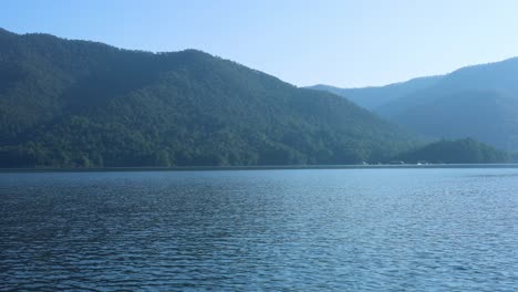 calm water with mountain backdrop over time