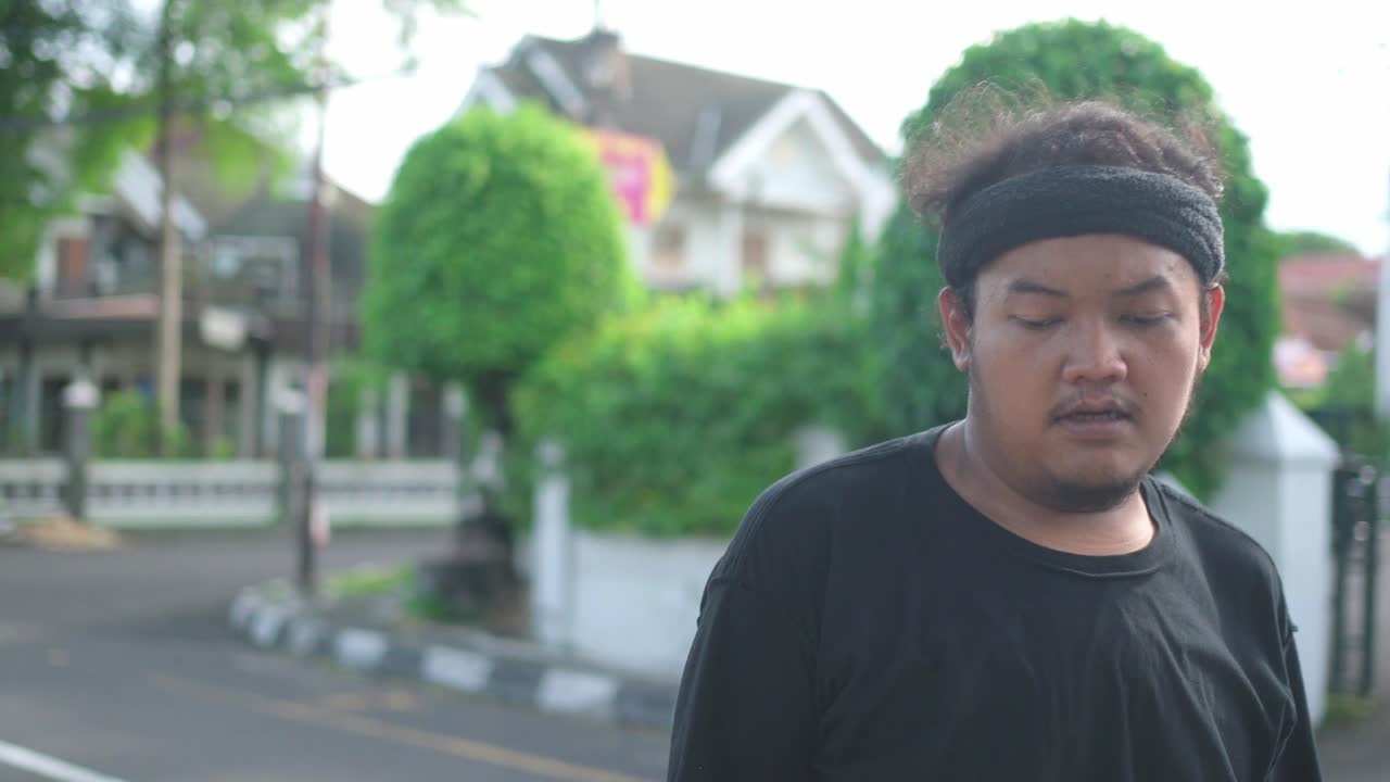 Man in a Black T-shirt on the Street