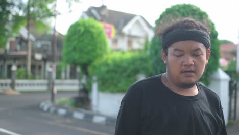 man in a black t-shirt on the street