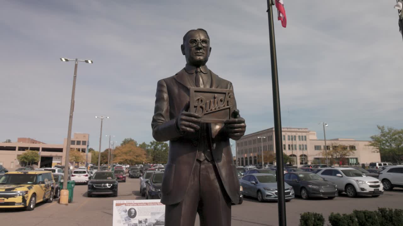 Statue of auto pioneer David Buick in Flint, Michigan with gimbal video moving forward