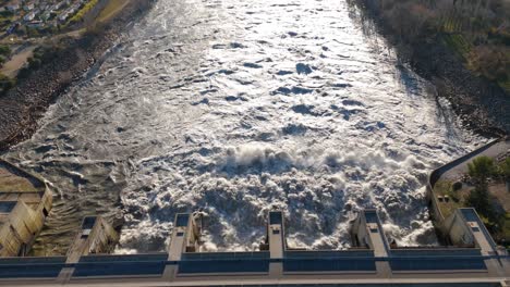 powerful release of dam water captured in aerial view with torrents unleashed