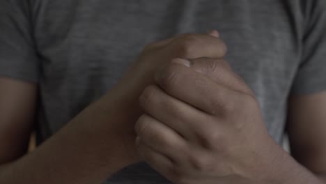 close up of adult asian male scratching back of hands