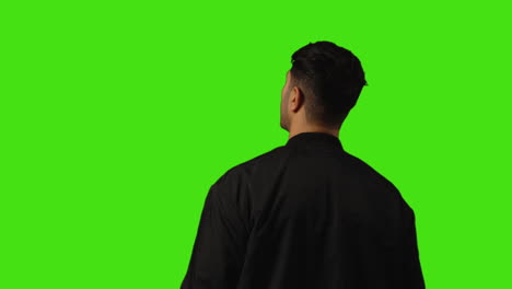 Rear-View-Of-Bored-Or-Fed-Up-Young-Man-Standing-And-Waiting-Against-Green-Screen-Background-1