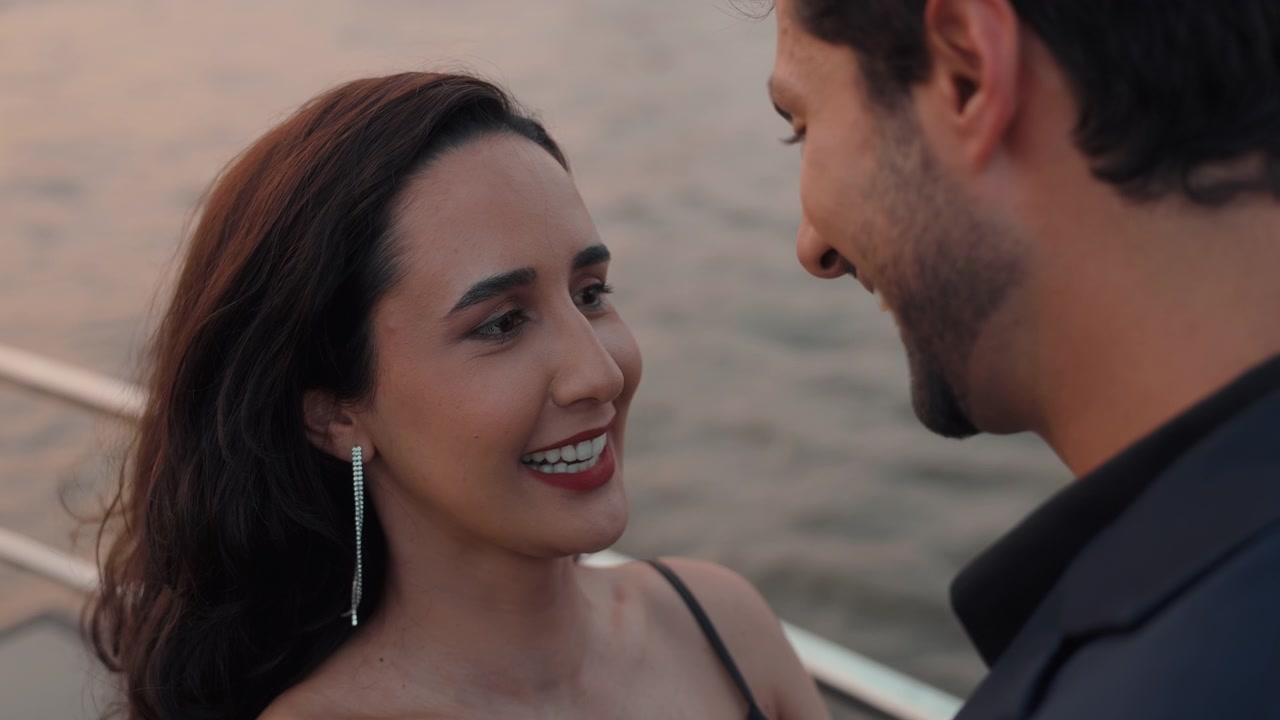 Elegant Couple Smiling and Conversing During a Sunset Date