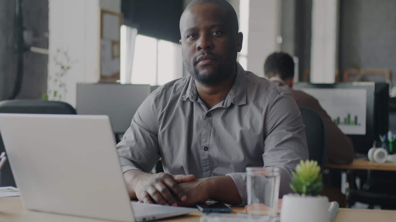 Man Working at a Laptop in an Office